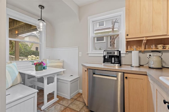 2021 Bever Ave SE, Cedar Rapids, IA 52403 - kitchen with dishwasher, light brown cabinetry, plenty of natural light, light countertops, and wainscoting