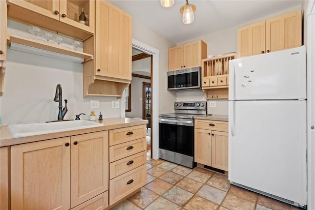 2021 Bever Ave SE, Cedar Rapids, IA 52403 - kitchen featuring stainless steel appliances, light brown cabinetry, stone finish floors, and open shelves