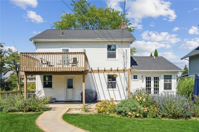 2021 Bever Ave SE, Cedar Rapids, IA 52403 - back of property with a chimney, a deck, a shingled roof, and french doors