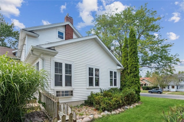 2021 Bever Ave SE, Cedar Rapids, IA 52403 - view of side of property featuring a chimney and a yard