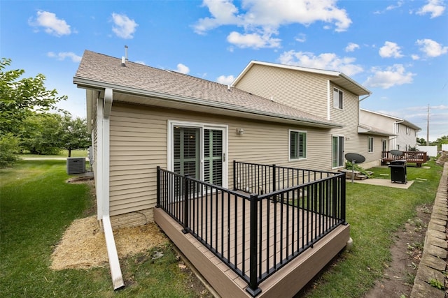 1458 Tower Ln NE Unit 12, Cedar Rapids, IA 52402 - back of property with a lawn, roof with shingles, a fire pit, and a deck
