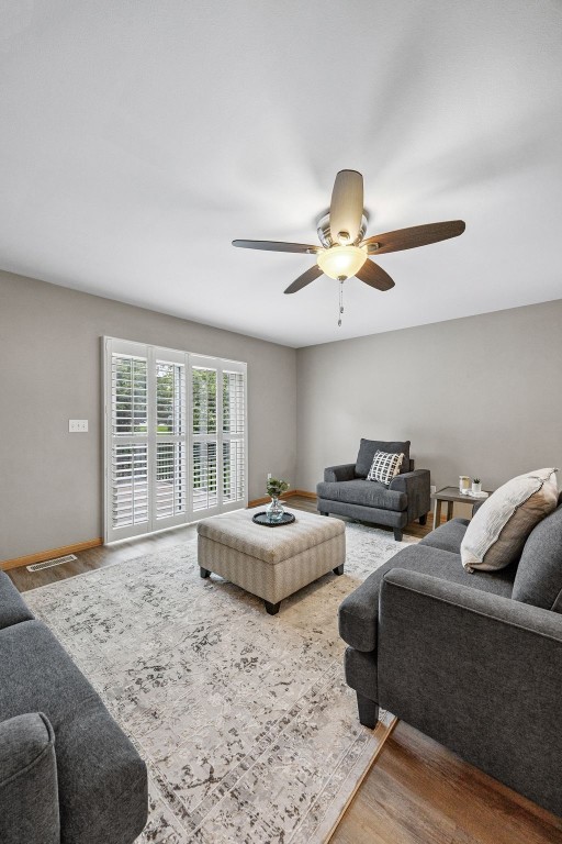 1458 Tower Ln NE Unit 12, Cedar Rapids, IA 52402 - living area featuring ceiling fan and wood finished floors