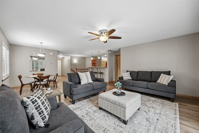 1458 Tower Ln NE Unit 12, Cedar Rapids, IA 52402 - living area with light wood-style floors and ceiling fan