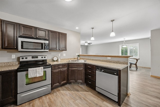 1458 Tower Ln NE Unit 12, Cedar Rapids, IA 52402 - kitchen featuring stainless steel appliances, light wood-type flooring, dark brown cabinets, and recessed lighting
