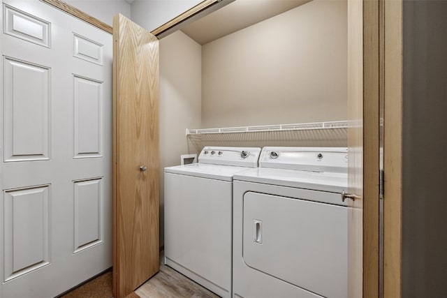 1458 Tower Ln NE Unit 12, Cedar Rapids, IA 52402 - laundry room featuring washing machine and clothes dryer and light wood-type flooring