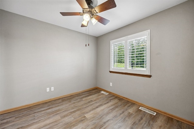 1458 Tower Ln NE Unit 12, Cedar Rapids, IA 52402 - unfurnished room with wood finished floors and a ceiling fan
