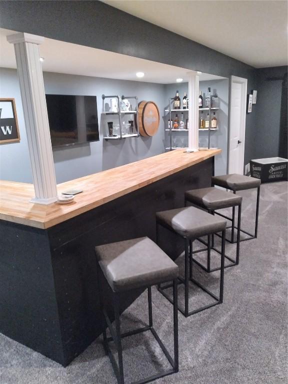 8903 Norway Dr NE, Cedar Rapids, IA 52402 - indoor bar featuring carpet floors, ornate columns, and recessed lighting
