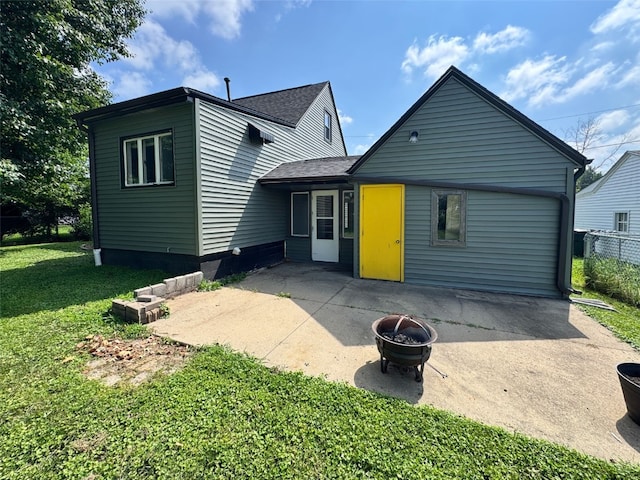 336 20th St NW, Cedar Rapids, IA 52405 - rear view of house with a fire pit, a patio area, and a shingled roof
