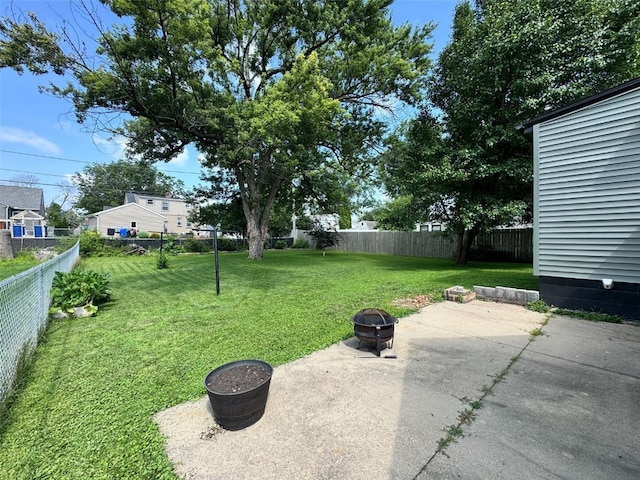 336 20th St NW, Cedar Rapids, IA 52405 - fenced backyard with an outdoor fire pit and a patio area