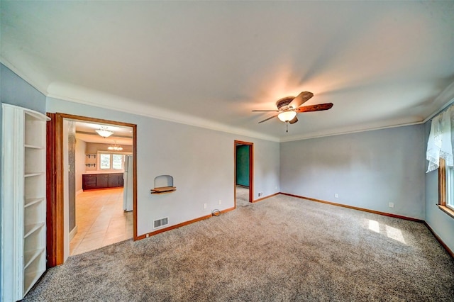336 20th St NW, Cedar Rapids, IA 52405 - empty room with light colored carpet, a ceiling fan, and crown molding