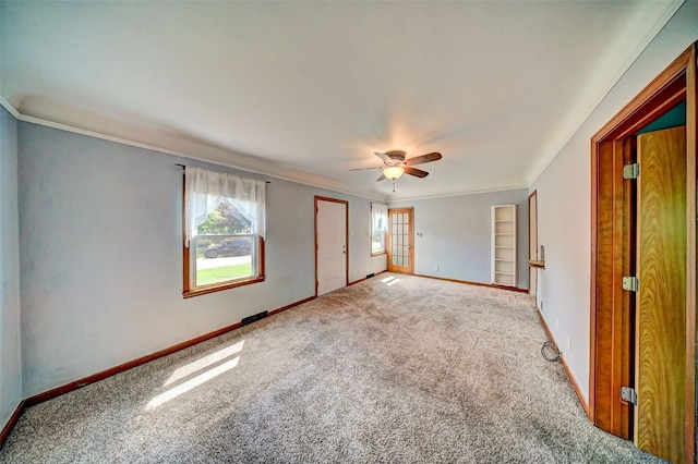 336 20th St NW, Cedar Rapids, IA 52405 - unfurnished bedroom with carpet, ornamental molding, a ceiling fan, and a closet