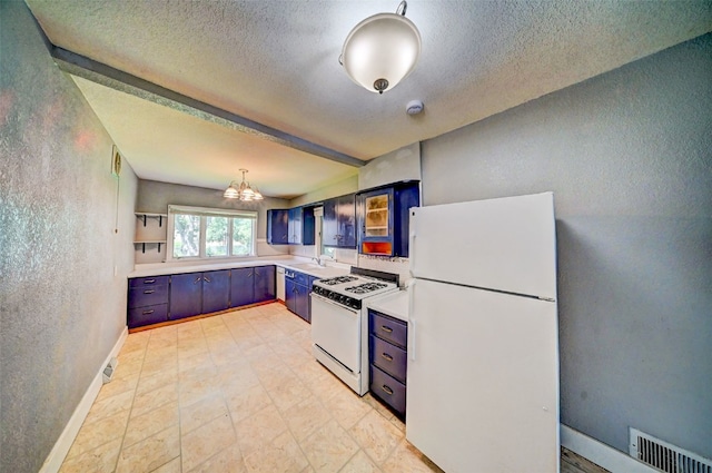 336 20th St NW, Cedar Rapids, IA 52405 - kitchen with white appliances, a textured wall, light countertops, a textured ceiling, and a chandelier