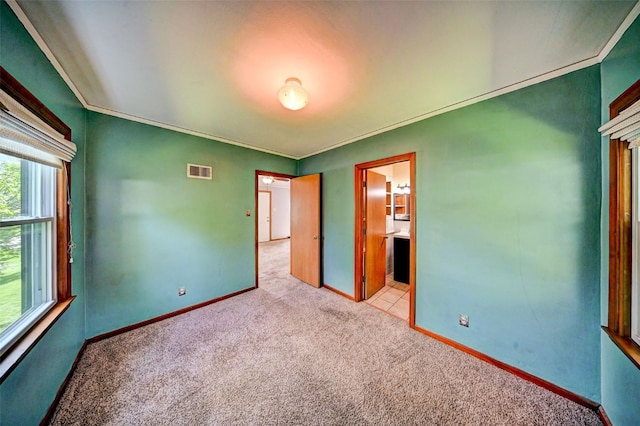 336 20th St NW, Cedar Rapids, IA 52405 - unfurnished bedroom with carpet floors, ornamental molding, and ensuite bath