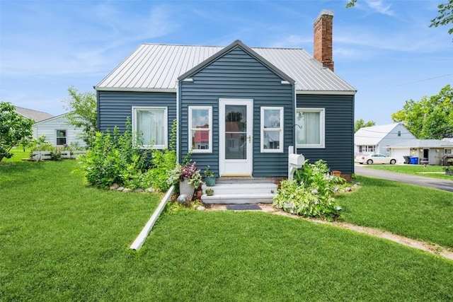 2000 Hamilton St SW, Cedar Rapids, IA 52404 - bungalow-style house with a front yard, a chimney, and a metal roof