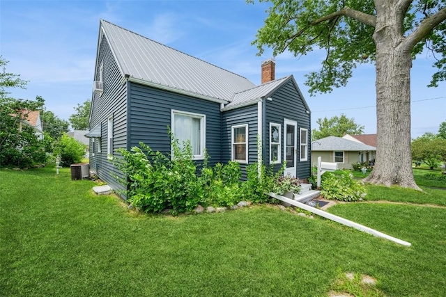 2000 Hamilton St SW, Cedar Rapids, IA 52404 - back of property with a chimney, a yard, and a metal roof