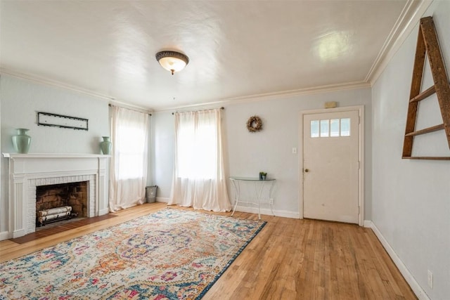 2000 Hamilton St SW, Cedar Rapids, IA 52404 - foyer with ornamental molding, wood finished floors, and a fireplace