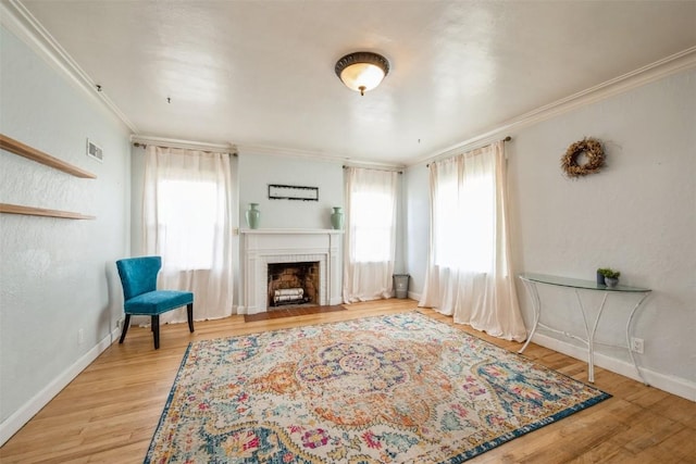 2000 Hamilton St SW, Cedar Rapids, IA 52404 - living room with wood finished floors, crown molding, and a brick fireplace