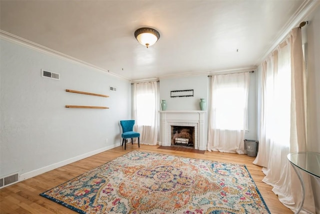 2000 Hamilton St SW, Cedar Rapids, IA 52404 - living area featuring a fireplace with flush hearth, ornamental molding, and wood finished floors