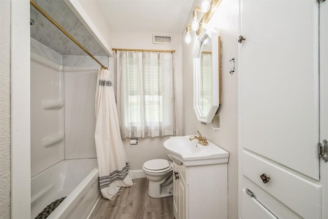 2000 Hamilton St SW, Cedar Rapids, IA 52404 - bathroom with vanity, wood finished floors, and shower / bath combo with shower curtain