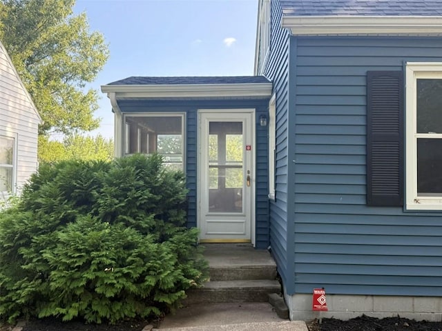 1839 K Ave NE, Cedar Rapids, IA 52402 - view of exterior entry featuring a shingled roof