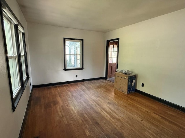 1839 K Ave NE, Cedar Rapids, IA 52402 - empty room featuring dark wood-style floors and baseboards