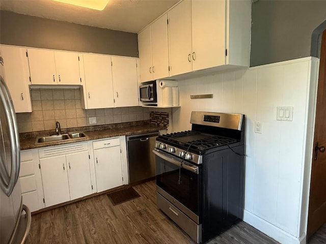 1839 K Ave NE, Cedar Rapids, IA 52402 - kitchen featuring appliances with stainless steel finishes, dark wood-style floors, white cabinetry, and backsplash