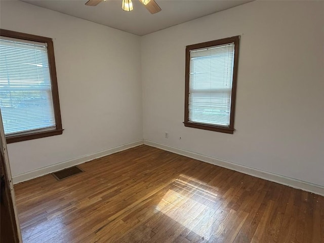 1839 K Ave NE, Cedar Rapids, IA 52402 - empty room with wood finished floors and ceiling fan