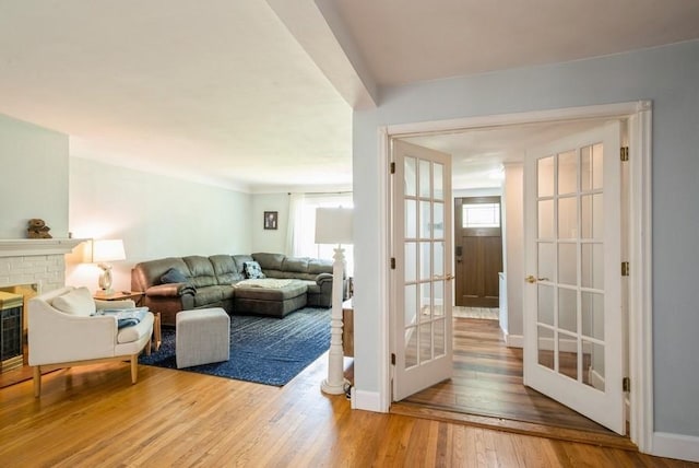 1935 1st Ave SW, Cedar Rapids, IA 52405 - living area with plenty of natural light, hardwood / wood-style floors, and a brick fireplace