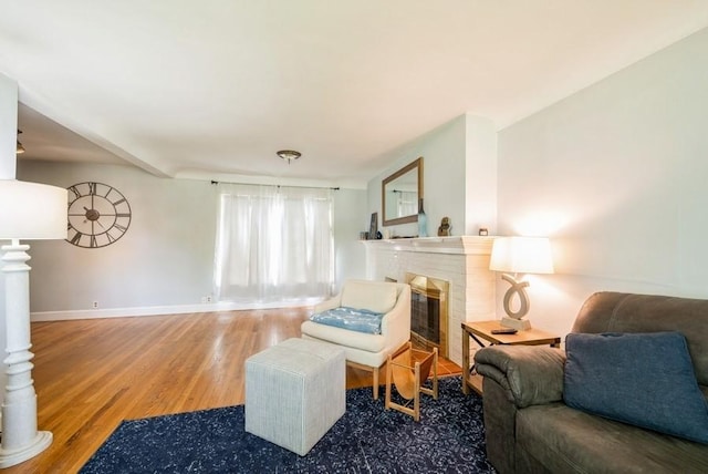 1935 1st Ave SW, Cedar Rapids, IA 52405 - living room featuring wood finished floors and a brick fireplace