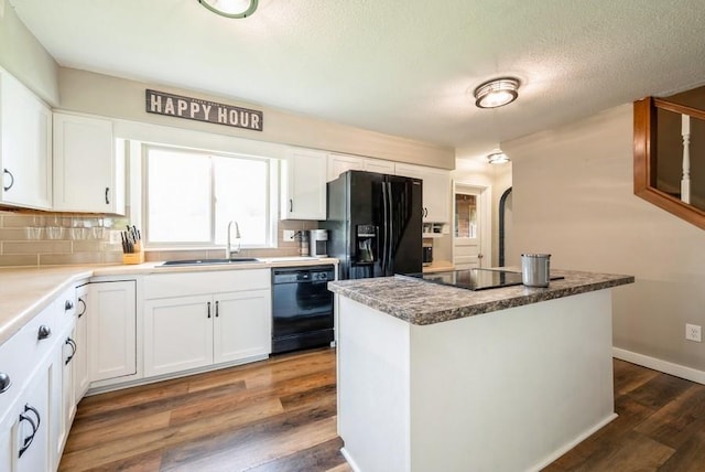 1935 1st Ave SW, Cedar Rapids, IA 52405 - kitchen with dark wood-style flooring, black appliances, white cabinetry, and a textured ceiling