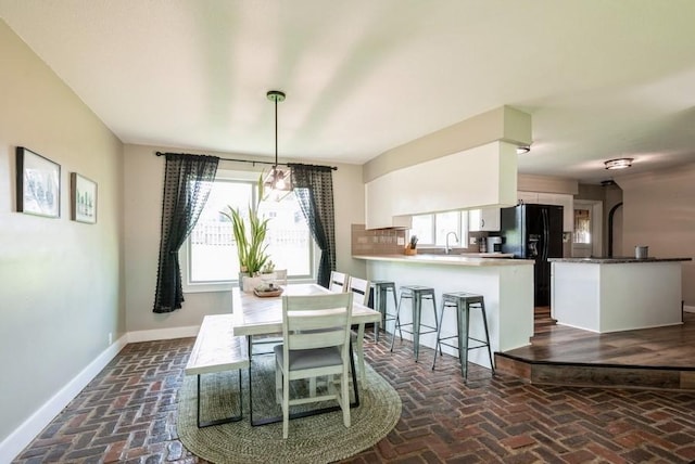 1935 1st Ave SW, Cedar Rapids, IA 52405 - dining room featuring brick flooring and baseboards