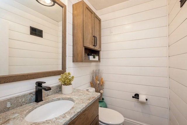 1935 1st Ave SW, Cedar Rapids, IA 52405 - bathroom featuring vanity and wood walls