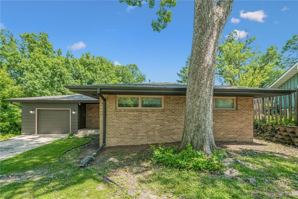 1372 Norwood Dr SE, Cedar Rapids, IA 52403 - view of front of home with a garage, brick siding, and driveway