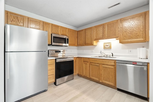 3060 Wilson Ave SW Unit 7, Cedar Rapids, IA 52404 - kitchen featuring appliances with stainless steel finishes, light countertops, and light wood-type flooring