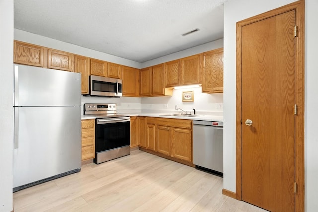 3060 Wilson Ave SW Unit 7, Cedar Rapids, IA 52404 - kitchen featuring stainless steel appliances, light wood-style floors, and light countertops