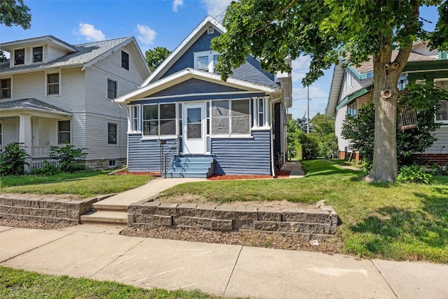 1818 Park Ave SE, Cedar Rapids, IA 52403 - view of front of house with a sunroom, a front yard, and entry steps