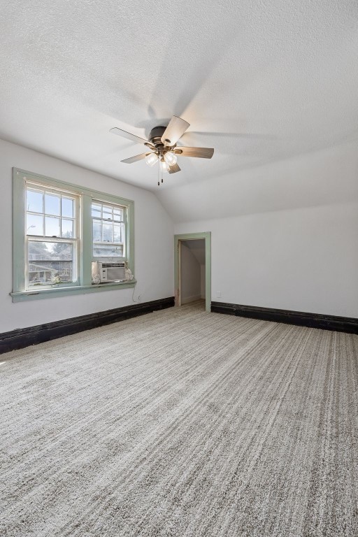 1818 Park Ave SE, Cedar Rapids, IA 52403 - bonus room featuring a ceiling fan, a textured ceiling, and carpet flooring