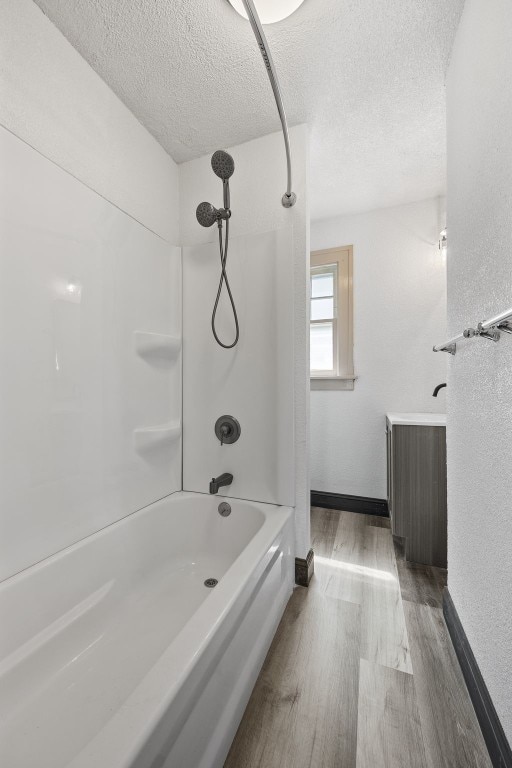 1818 Park Ave SE, Cedar Rapids, IA 52403 - bathroom with wood finished floors, a textured ceiling, and shower / bathtub combination