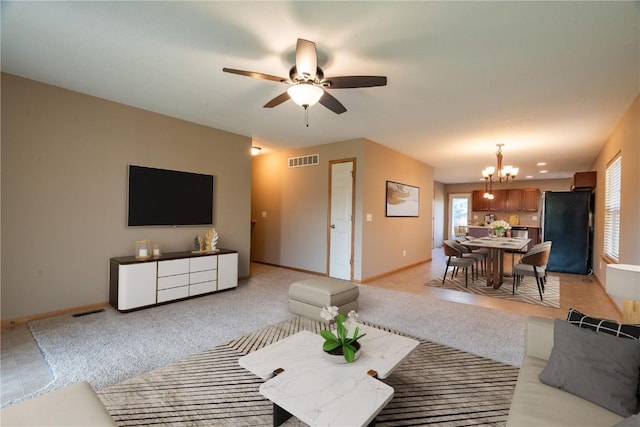 6045 Ridgewood Meadows Ln NE, Cedar Rapids, IA 52411 - living room featuring a chandelier and ceiling fan