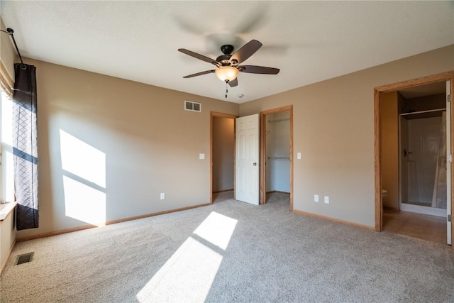 6045 Ridgewood Meadows Ln NE, Cedar Rapids, IA 52411 - unfurnished bedroom with light carpet, ensuite bath, a spacious closet, and ceiling fan