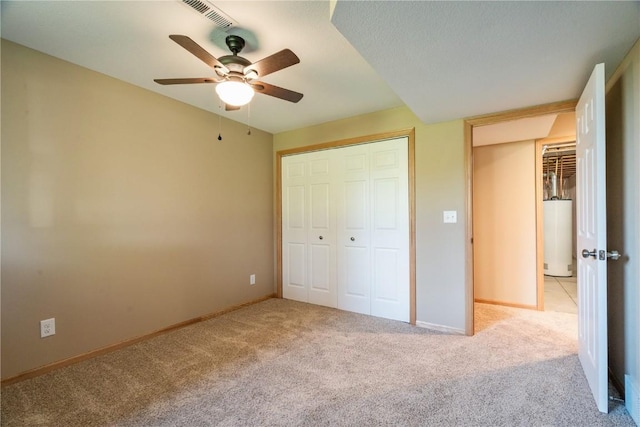 6045 Ridgewood Meadows Ln NE, Cedar Rapids, IA 52411 - unfurnished bedroom featuring light carpet, a closet, water heater, and ceiling fan