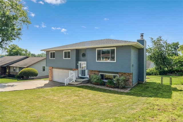4185 Richland Dr, Cedar Rapids, IA 52405 - bi-level home featuring brick siding, an attached garage, a chimney, and driveway