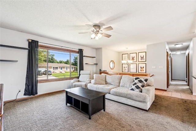 4185 Richland Dr, Cedar Rapids, IA 52405 - living room with light colored carpet, a ceiling fan, a textured ceiling, and light tile patterned flooring
