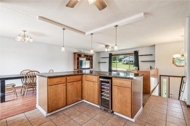 4185 Richland Dr, Cedar Rapids, IA 52405 - kitchen with a ceiling fan, a textured ceiling, dark countertops, open floor plan, and a chandelier