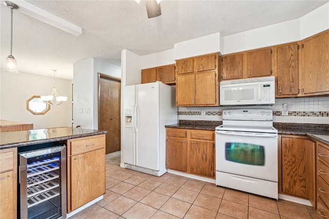 4185 Richland Dr, Cedar Rapids, IA 52405 - kitchen with white appliances, beverage cooler, dark countertops, a chandelier, and tasteful backsplash