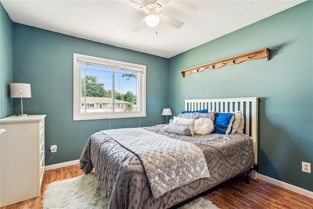 4185 Richland Dr, Cedar Rapids, IA 52405 - bedroom with wood finished floors, ceiling fan, and a textured ceiling