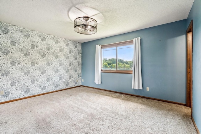 4185 Richland Dr, Cedar Rapids, IA 52405 - carpeted spare room featuring baseboards and a textured ceiling