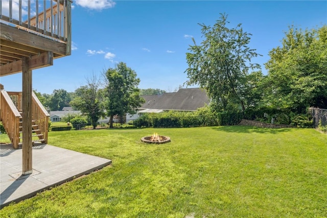 4185 Richland Dr, Cedar Rapids, IA 52405 - fenced backyard featuring a patio area, a fire pit, and stairway