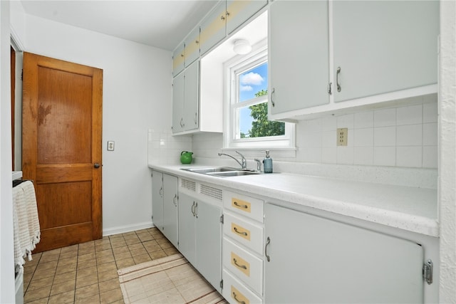 1039 27th St NE, Cedar Rapids, IA 52214 - kitchen featuring decorative backsplash, light countertops, and light tile patterned floors
