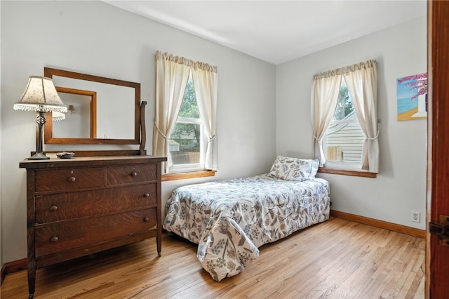 1039 27th St NE, Cedar Rapids, IA 52214 - bedroom with multiple windows and light wood-type flooring